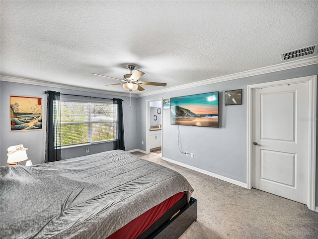 carpeted bedroom with ornamental molding, connected bathroom, ceiling fan, and a textured ceiling