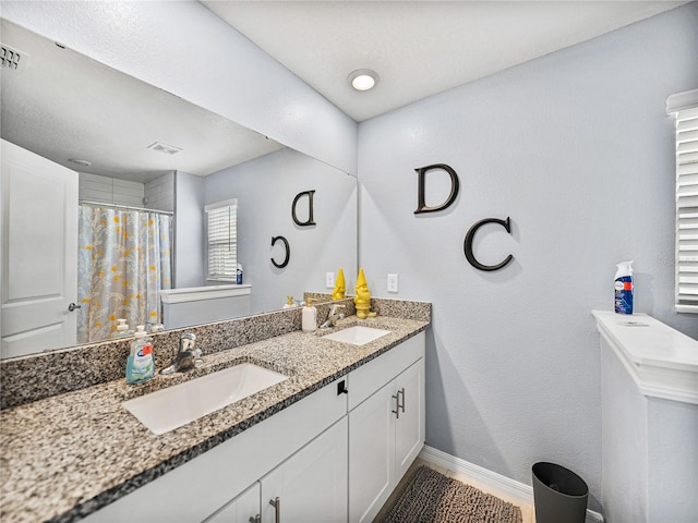 bathroom with vanity and curtained shower