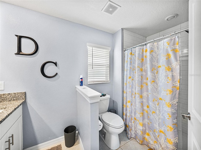 bathroom with curtained shower, vanity, toilet, tile patterned floors, and a textured ceiling