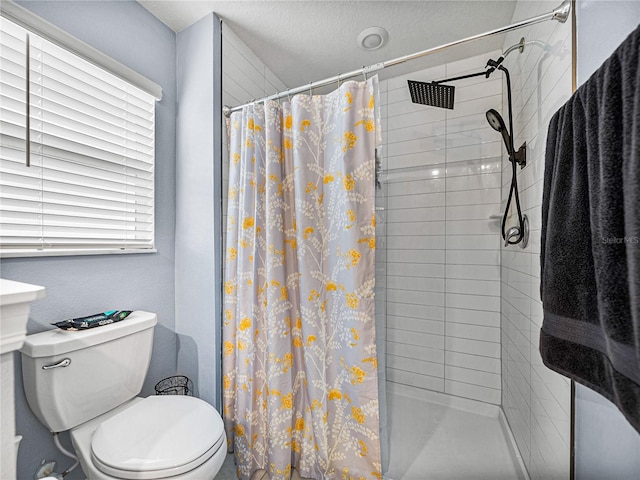 bathroom with a shower with curtain and toilet