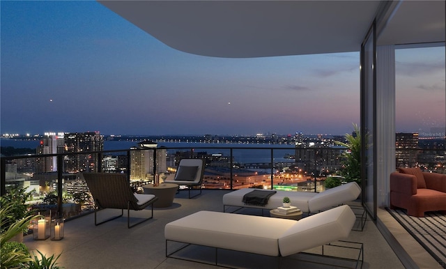 patio terrace at dusk with a balcony and a water view