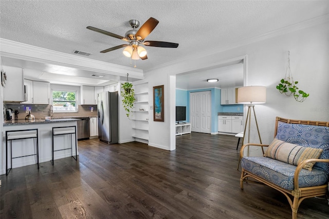 kitchen featuring stainless steel appliances, white cabinetry, and dark hardwood / wood-style flooring