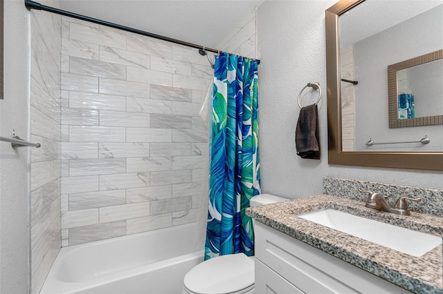 full bathroom with vanity, toilet, shower / bath combo with shower curtain, and a textured ceiling