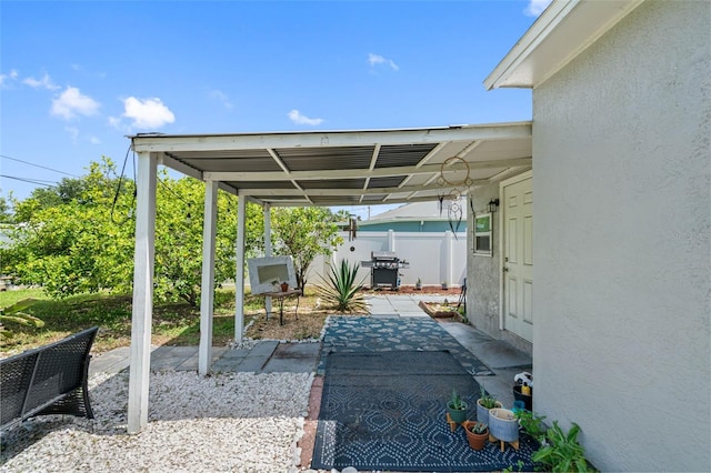 view of patio / terrace featuring a carport and a grill