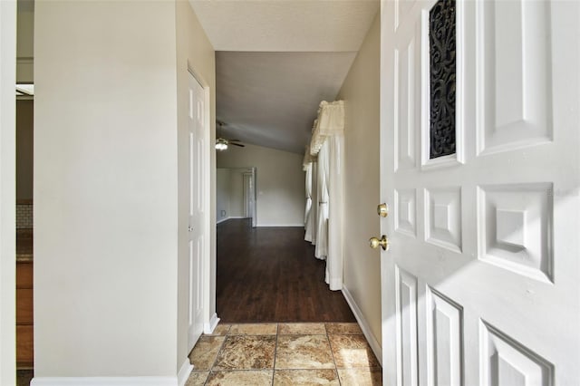 hallway with vaulted ceiling