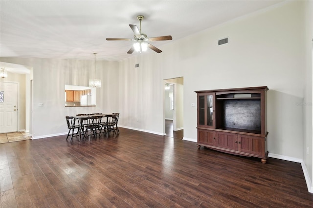 living room featuring dark hardwood / wood-style floors and ceiling fan with notable chandelier