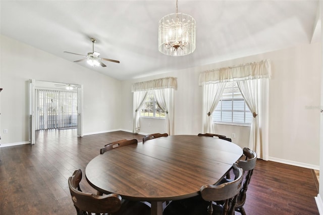 dining area with dark hardwood / wood-style flooring, ceiling fan with notable chandelier, and vaulted ceiling