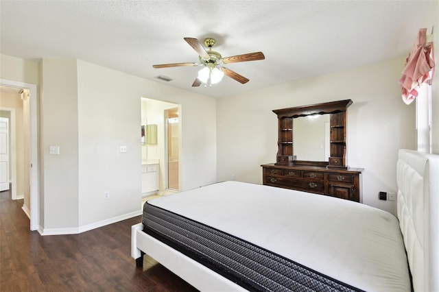 bedroom with ensuite bath, dark hardwood / wood-style floors, and ceiling fan