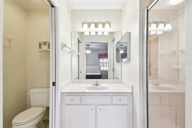 bathroom with vanity, toilet, and a shower with door