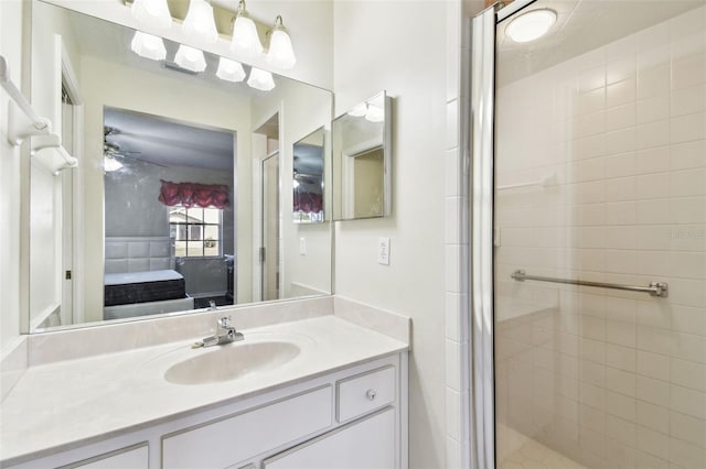 bathroom featuring vanity, ceiling fan, and walk in shower