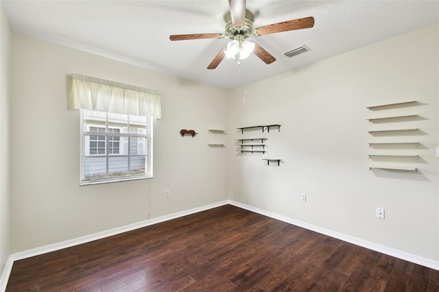 empty room with hardwood / wood-style flooring, a textured ceiling, and ceiling fan