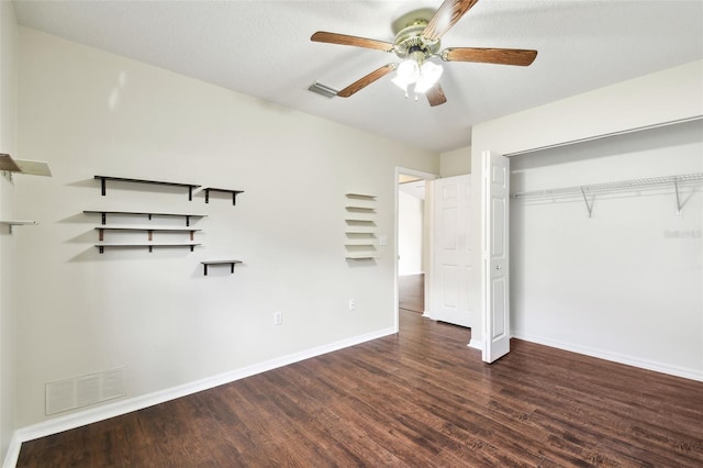 unfurnished bedroom featuring dark hardwood / wood-style flooring, a textured ceiling, a closet, and ceiling fan