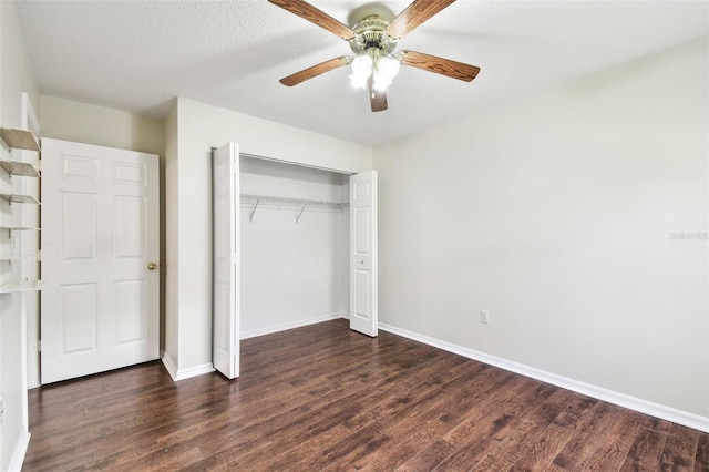 unfurnished bedroom with dark wood-type flooring, a closet, and ceiling fan