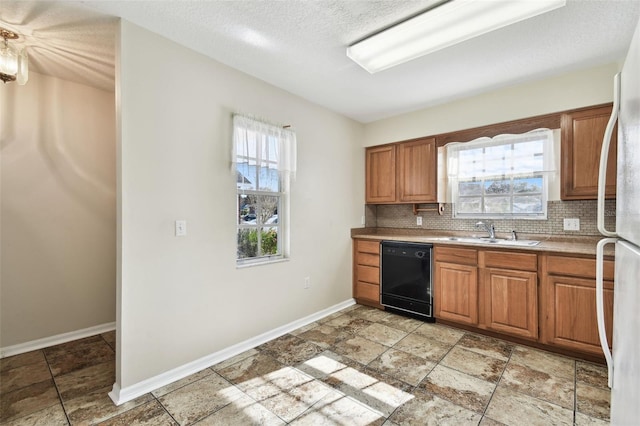 kitchen with sink, dishwasher, tasteful backsplash, a textured ceiling, and white fridge