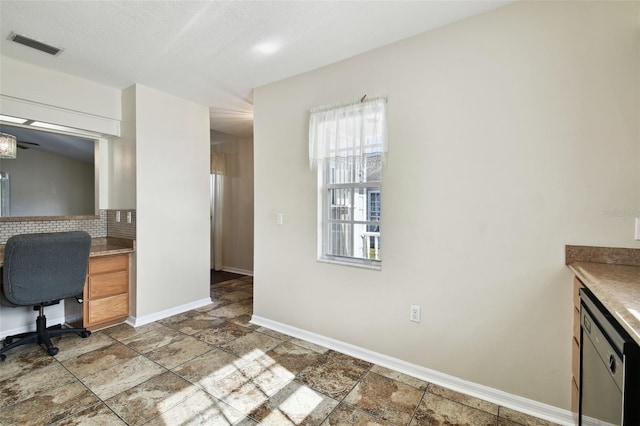 interior space with dishwasher and backsplash