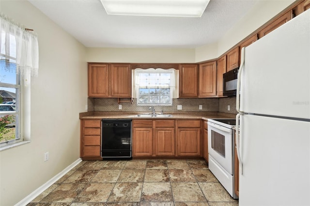 kitchen with sink, decorative backsplash, and black appliances