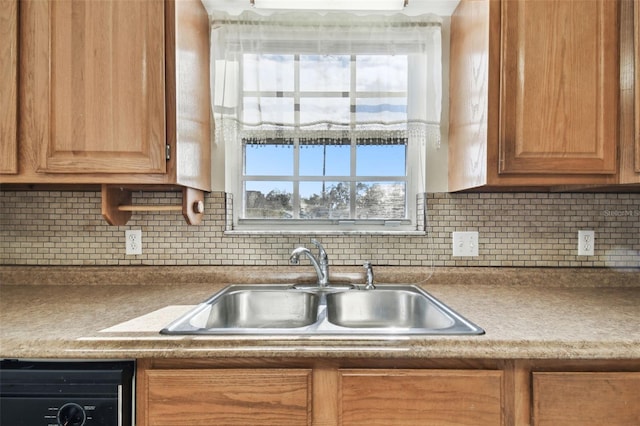 kitchen with dishwasher, sink, and decorative backsplash