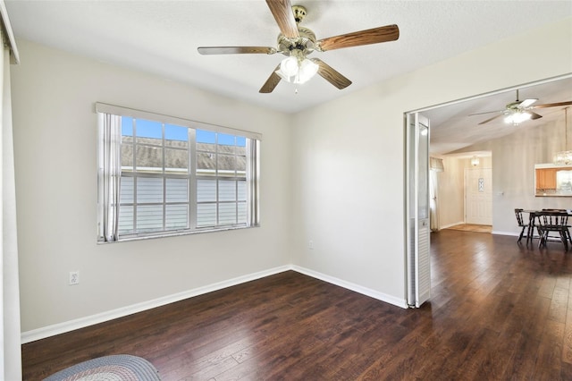 spare room with dark wood-type flooring and ceiling fan