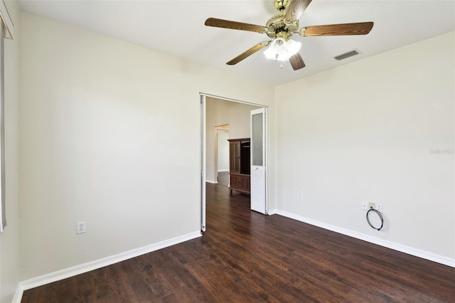 spare room with ceiling fan and dark hardwood / wood-style flooring