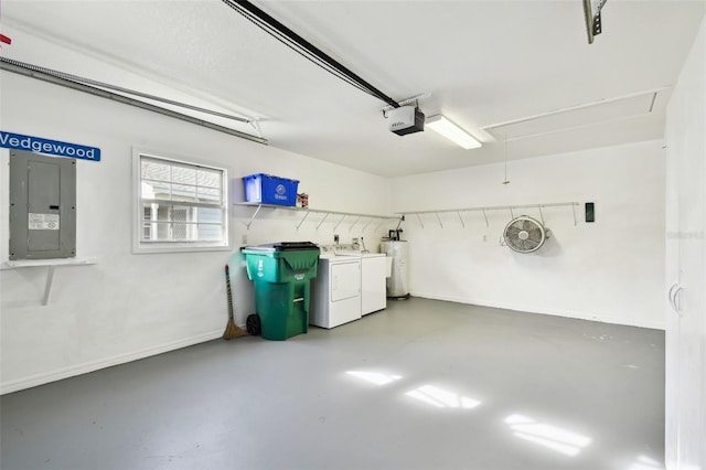 garage featuring water heater, a garage door opener, electric panel, and independent washer and dryer