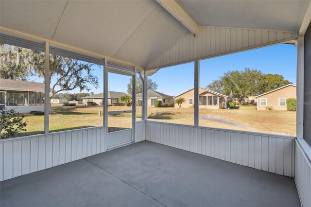 unfurnished sunroom with vaulted ceiling