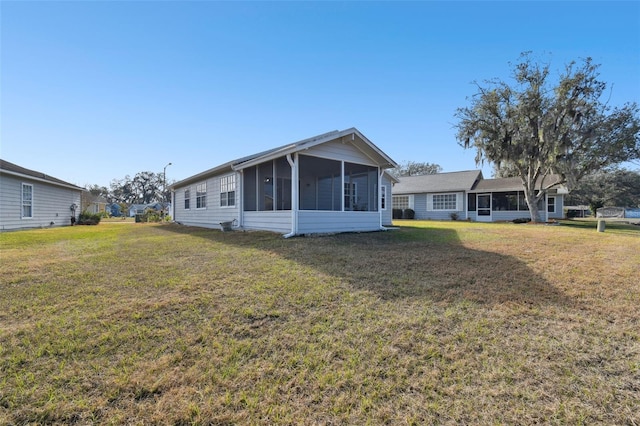 view of front of house featuring a front lawn and a sunroom