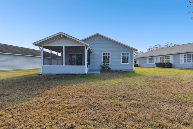 back of property featuring a yard and a sunroom