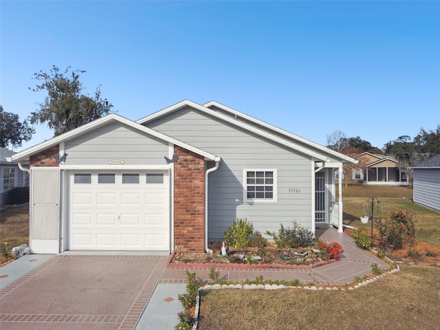 single story home featuring a garage and a front yard