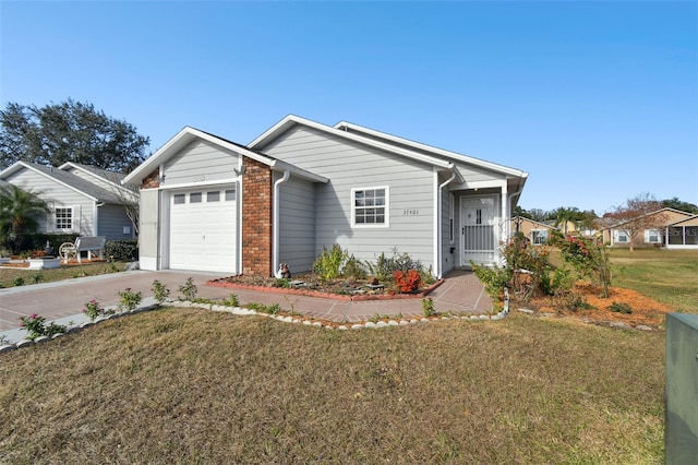 single story home with a front lawn, a garage, and concrete driveway