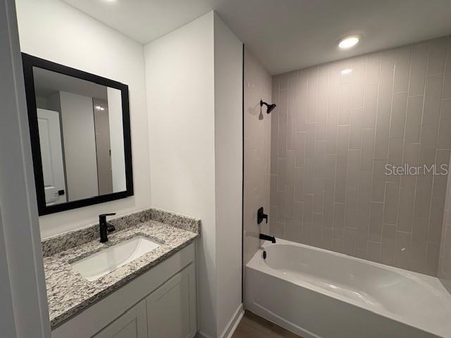 bathroom featuring vanity and tiled shower / bath combo