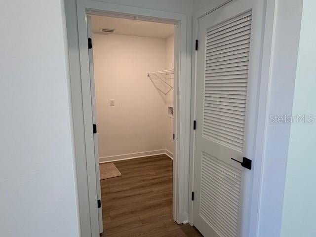 clothes washing area featuring dark hardwood / wood-style floors