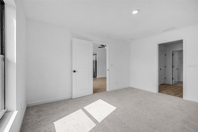 unfurnished bedroom featuring baseboards, recessed lighting, carpet flooring, and visible vents