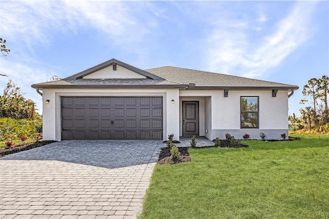 ranch-style home featuring an attached garage, stucco siding, a front lawn, and decorative driveway