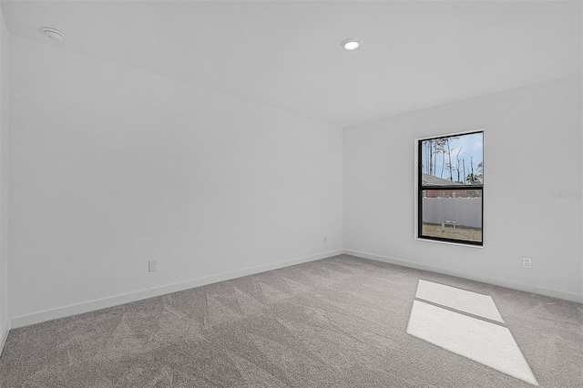 unfurnished room featuring carpet flooring, baseboards, and recessed lighting