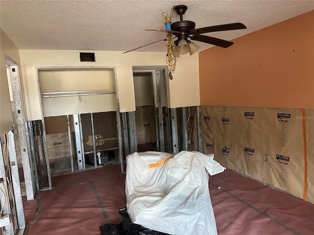 bedroom with a textured ceiling and ceiling fan