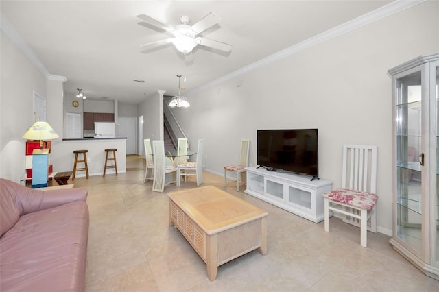 tiled living room with crown molding and ceiling fan with notable chandelier