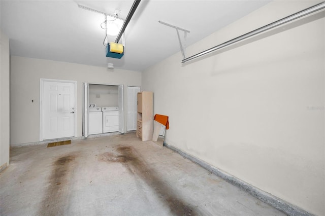 garage featuring separate washer and dryer and a garage door opener