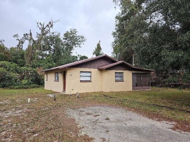 view of side of home featuring a lawn