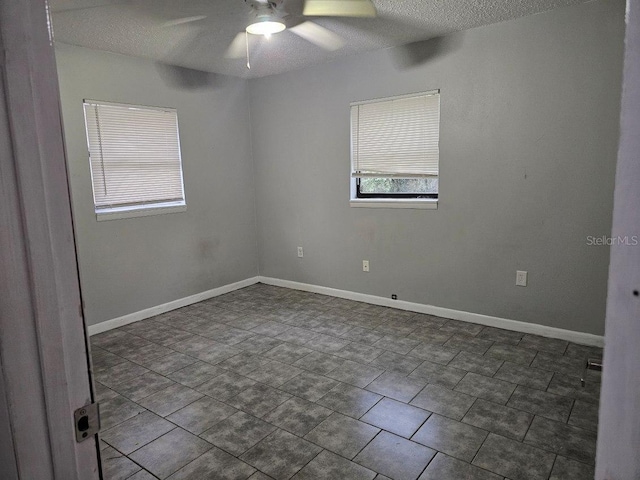 spare room featuring a textured ceiling and ceiling fan