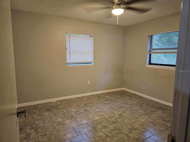 spare room featuring ceiling fan and a textured ceiling