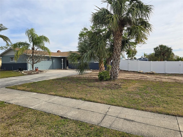 view of front of home with a garage and a front lawn