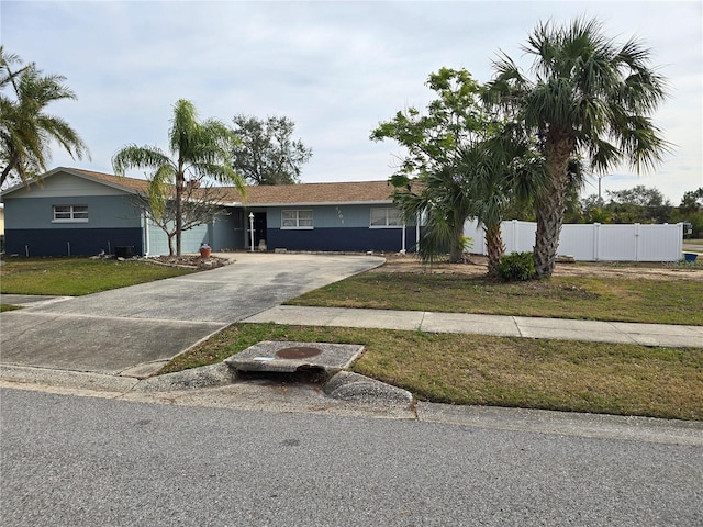 single story home featuring a front lawn