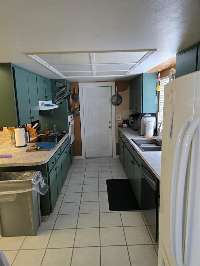 kitchen featuring white appliances, sink, and light tile patterned floors