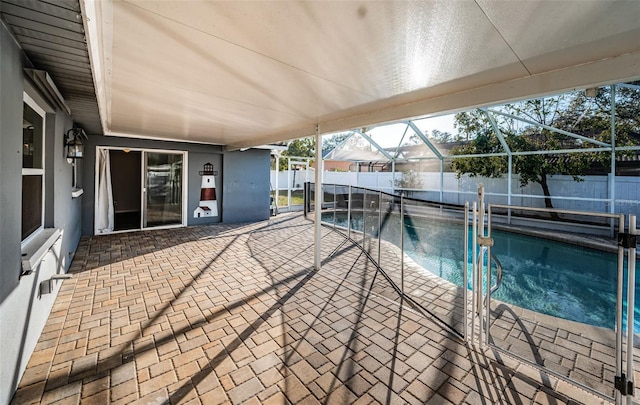 view of pool featuring a patio and glass enclosure