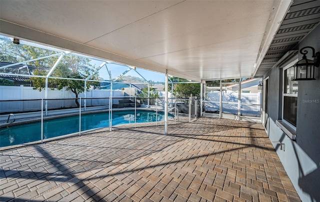 view of swimming pool featuring a patio area and glass enclosure