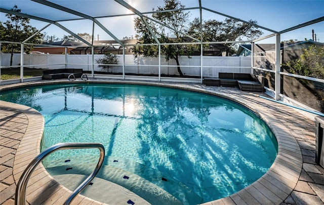 view of pool featuring a patio and glass enclosure