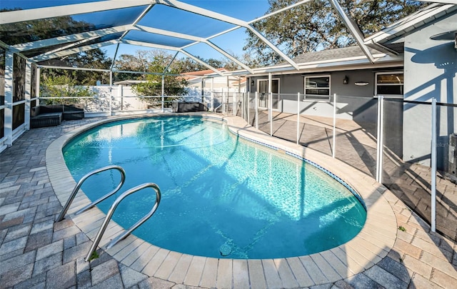 view of pool with a patio and a lanai