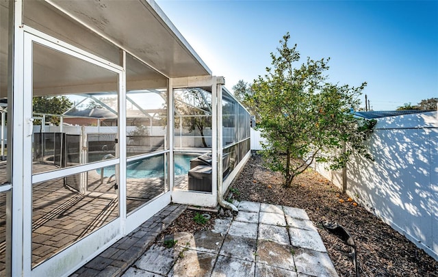 view of patio featuring a fenced in pool and a lanai