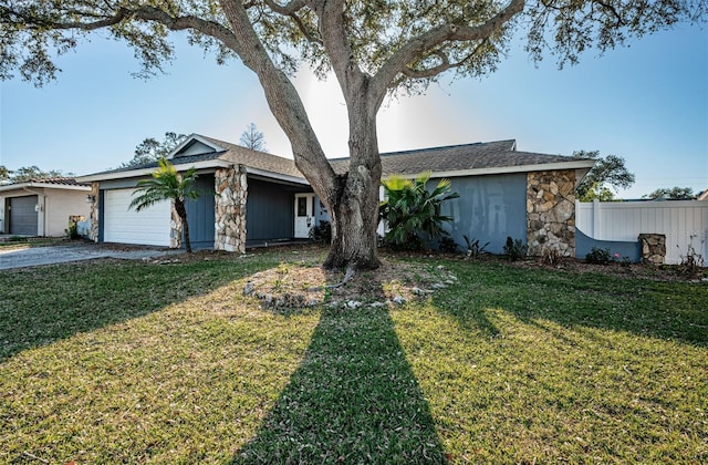 ranch-style home with a garage and a front yard