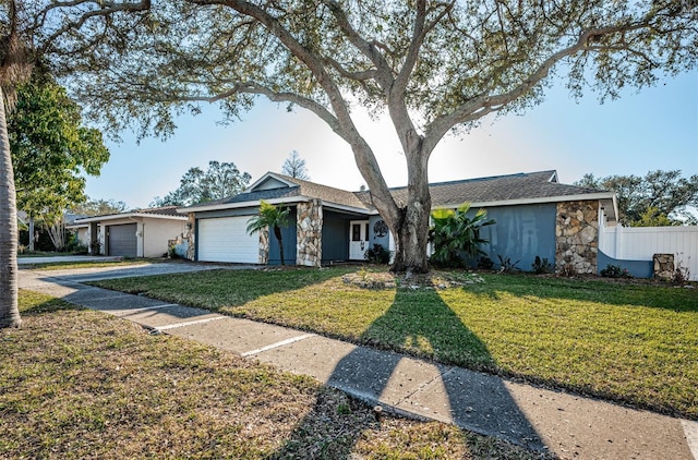 ranch-style house featuring a garage and a front yard